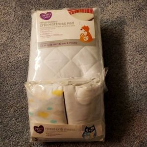 Crib sheets and mattress pad.